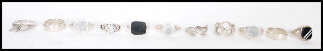 A selection of silver rings to include a signet rings and band rings. Total weight approx 58g.