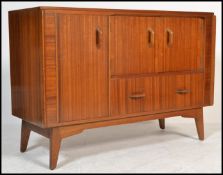 A retro vintage 20th Century teak wood Danish inspired sideboard, two short cupboard doors over a