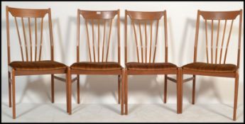 A set of four retro 20th Century teak Danish inspired dining chairs. Raised on tapering supports