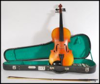 A 20th Century student violin and bow, in original case with applied makers badge for Skylark Made