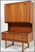A retro 20th Century Turnidge of London teak wood bureau cabinet, fully appointed fall front above