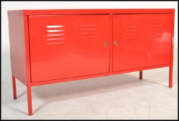 A vintage retro style metal tool cabinet / sideboard, two swing doors raised on square legs finished