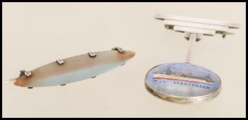 Two vintage 20th century brooches to include an Art Deco style graduated bar brooch stamped sterling