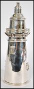 A 20th century silver plated cocktail shaker in the form of a lighthouse. Measures approx 36 cm.