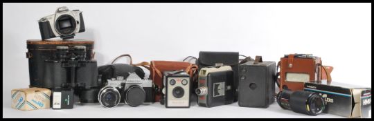 A collection of vintage cameras to include a Kodak Brownie Flash III, Praktica MTL3, a cine Kodak