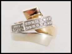 A hallmarked Italian 14ct white and yellow gold and diamond ring in a modernist style. Weight 8.