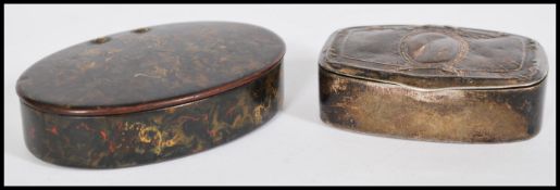 Two antique snuff boxes one being a silver white metal example of lozenge form with plain armorial