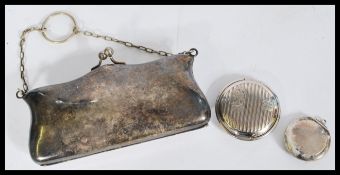 A 20th century silver white metal purse with a chain strap with two compacts one being early 20th