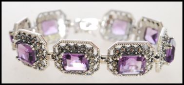A stamped 925 silver panel bracelet set with emerald cut amethyst and marcasite, set into pierced