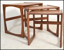A vintage retro 20th century G-Plan teak wood nest of tables raised on tapered supports. Measures 50