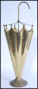 A 20th century hammered brass stick stand in the form of an umbrella raised on a round base.