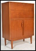 A retro 20th Century teak wood bureau, fall front with fully appointed interior over sliding