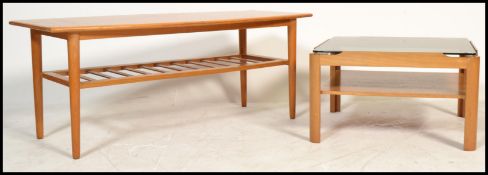 Two vintage retro 20th century teak wood coffee tables one raised on tapering supports united by