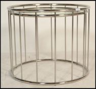 A contemporary retro style circular chrome coffee table, the frame comprising of chrome tubular
