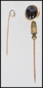 A 9ct / 375 hallmarked gold stick pin with inset clear stone together with another similar with