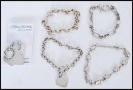 A selection of silver jewellery to include hooped leaf shaped earrings, an elephant spacer