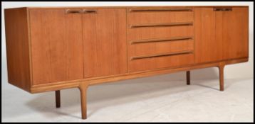A 1970's  Danish inspired McIntosh sideboard / credenza being raised with tapering legs comprising