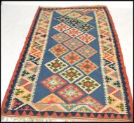 A vintage early 20th century decorative Kilim floor carpet rug having a blue / red geometric