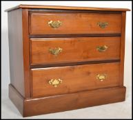 An Edwardian walnut cottage chest of drawers being raised on plinth base with a series of drawers