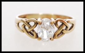 A 20th century hallmarked 9ct gold ring with a large oval cut white stone in a prong setting