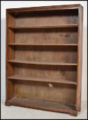 A mid century solid oak open window bookcase cabinet being raised on a plinth base with a series
