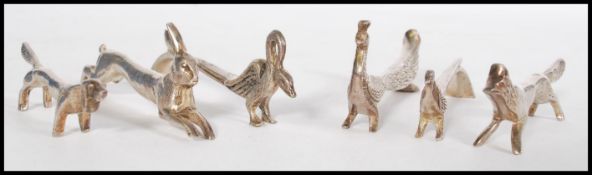 A set of six silver plated knife rests in the form to animals including a hare, a dog, a swan, a
