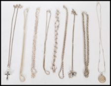A selection of silver chains to include square link, an Egyptian eye pendant and a silver