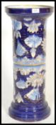 A Victorian 19th century majolica cobalt blue plant stand with floral decoration having later