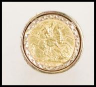 A large 9ct gold London hallmarked sovereign ring. The George V sovereign dated 1926 and faced St