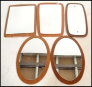 A collection of five vintage / retro teak frameless atomic shaped wall mirrors dating from the