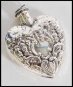 A stamped STERLING silver heart shaped perfume bottle in the shape of a heart with embossed