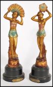 A pair of 20th century Art Deco cold cast metal dancer figurines, raised on round pedestal bases