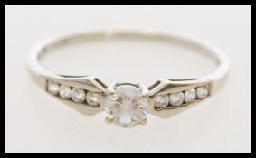 A 20th century hallmarked 9ct white gold ring set with one central white stone with smaller white