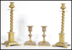 Two pairs of Victorian brass candle stick holders to include a pair of brass and copper candlesticks