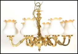 A 20th Century very heavy cast six branch brass chandelier, sweeping bulbous arms, each with glass