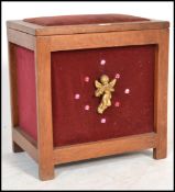 A 1920's solid mahogany and velour upholstered sewing box. The lift up top with open storage set