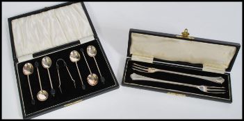 A selection of silver wares to include a set of silver hallmarked coffee bean spoons having bakelite