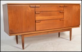 A retro 20th Century teak wood sideboard by Austinsuite having an arrangement of cupboards and
