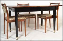A mid 20th Centuiry E. Gomme, G - Plan teak drop - leaf dining table raised on an ebonised base