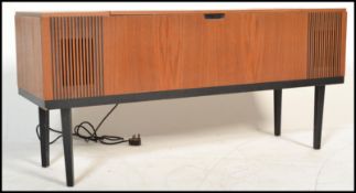 A mid century Danish influence teak wood sideboard - stereogram credenza. Raised on tapering legs