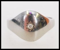 A 20th century hallmarked 9ct white gold signet ring with star inset diamond of approx 5pts.