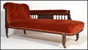 An early 20th Century Edwardian chaise longue with upholstered button back seat, scrolled back and