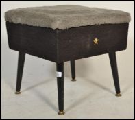 A mid century retro, circa 1950's ottoman footstool being raised on dansette style legs with black