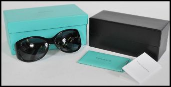 A pair of ladies Tiffany sunglasses complete in box with presentation / care case and some