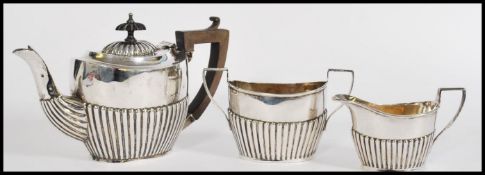 An early 20th century silver hallmarked three piece tea service in the boat pattern by William