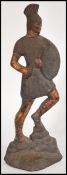 An early 20th century cast iron door stop in the form of a Roman soldier having painted details.