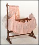 A mid 20th century childs oak crib having swing action. The crib with gallery sides complete with