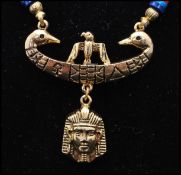 A vintage signed Art © Arthur Pepper gold-tone Egyptian revival pendant necklace. Measures 20 inches