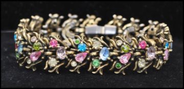 A 1950s signed Hollycraft bracelet set with pastel coloured rhinestones in a foliate setting