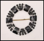 A 1920s French jet beaded buckle together with a faceted french jet bead knotted opera necklace.